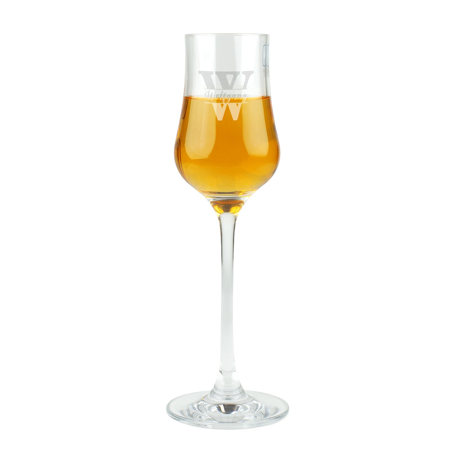 Freigestellte Studioaufnahme des Leonardo Grappaglases mit Gravur „Wolfgang“ und goldfarbenem Inhalt.