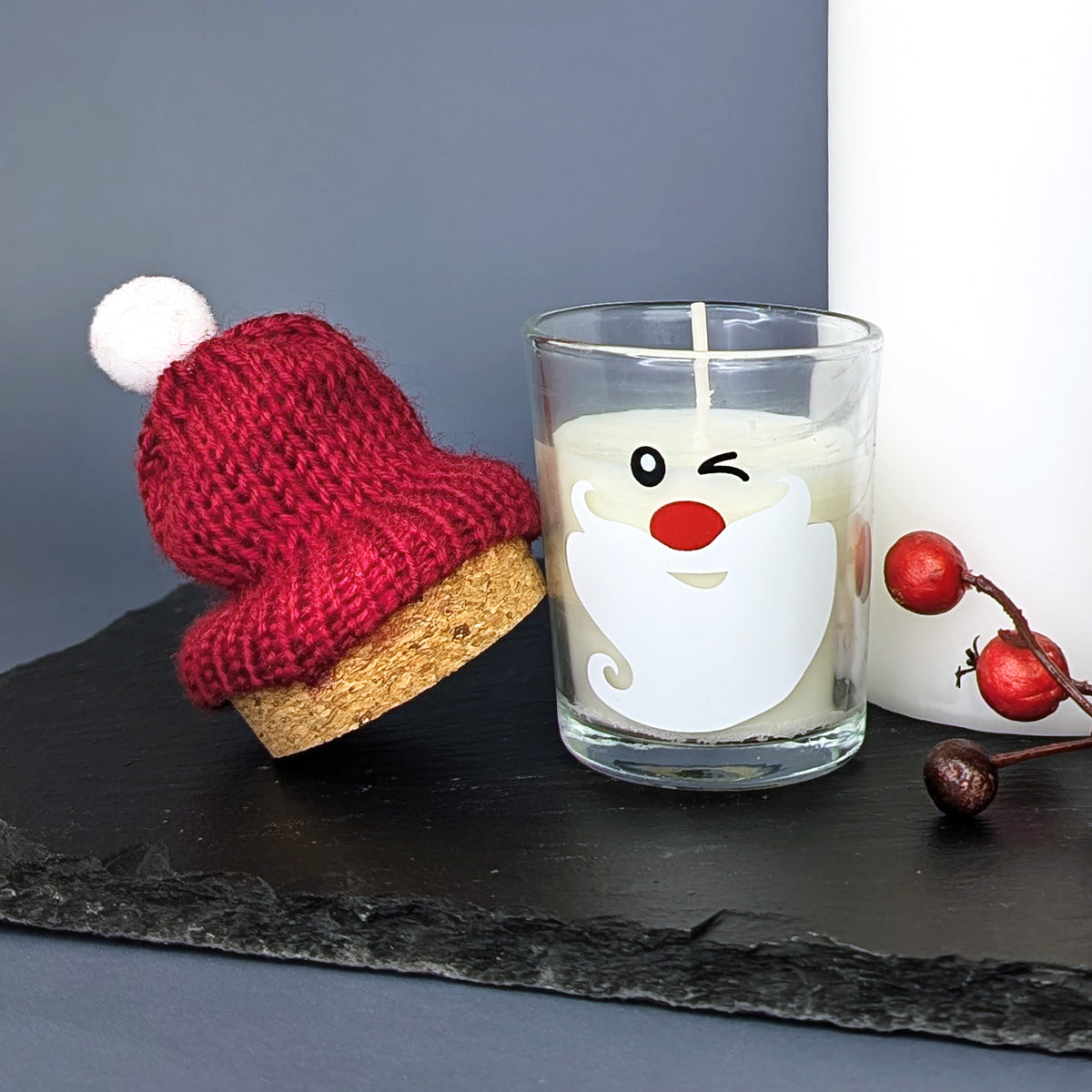 Kerze im Glas mit Korken und Pudelmütze im Santa-Design –