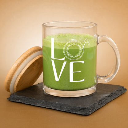 1. Glastasse mit grünem Getränk, weißem LOVE Stickmotiv und danebenstehendem Bambusdeckel auf Schieferplatte