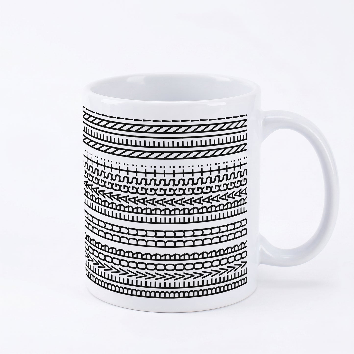 Keramiktasse mit schwarzem Linienmuster und verstecktem Spruch auf weißem Hintergrund