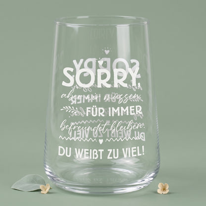 Leeres transparentes Trinkglas mit weißem Motivdruck und sichtbarer Spiegelung des Spruchs