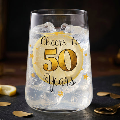 Trinkglas zum 50. Geburtstag mit Cheers to 50 Years Aufdruck, Eiswürfeln und Zitronenscheibe