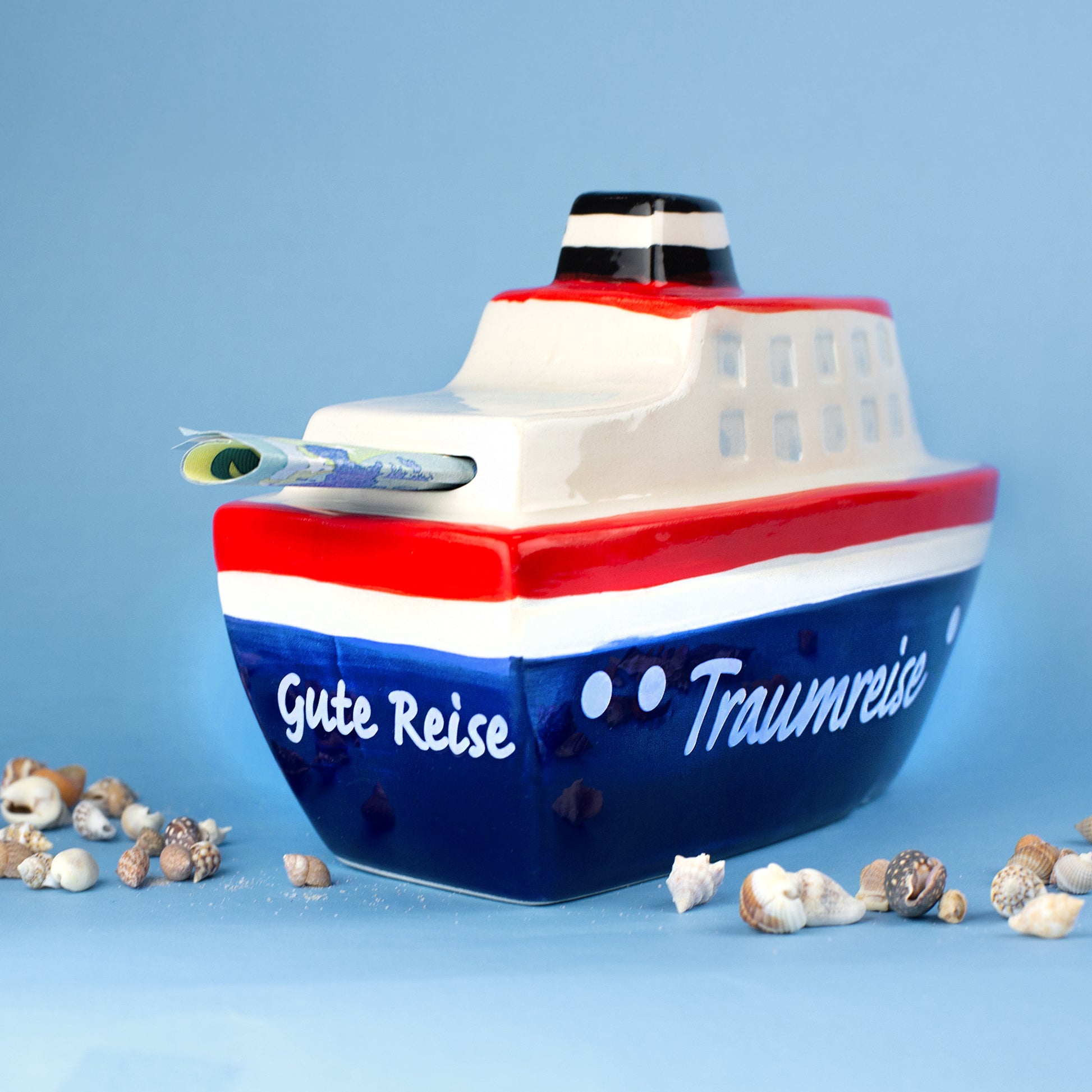 Rückseite der Schiff Spardose mit Aufschrift Gute Reise Traumreise und Geldschein