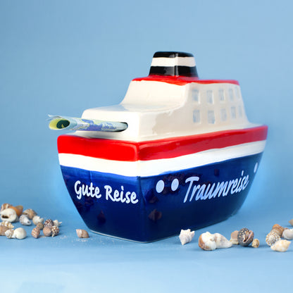 Rückseite der Schiff Spardose mit Aufschrift Gute Reise Traumreise und Geldschein