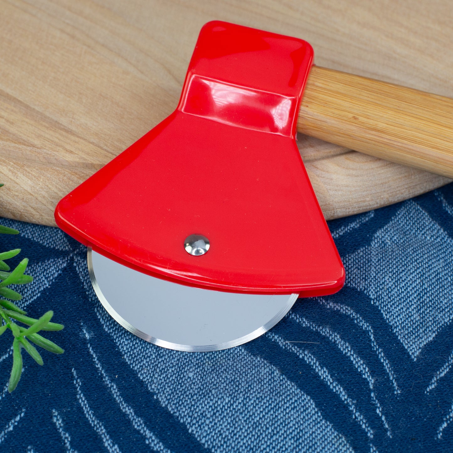 Detailaufnahme des Pizzaschneiders in Feuerwehr-Axtform mit Edelstahlrad