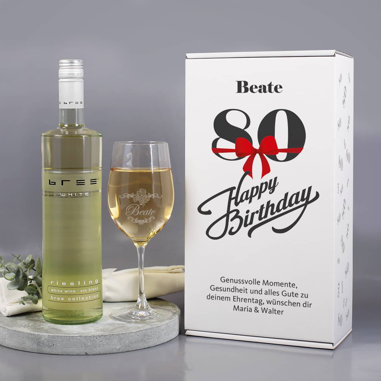 Weinset zum 80. Geburtstag mit Weinglas und Weißwein in bedruckter Geschenkverpackung