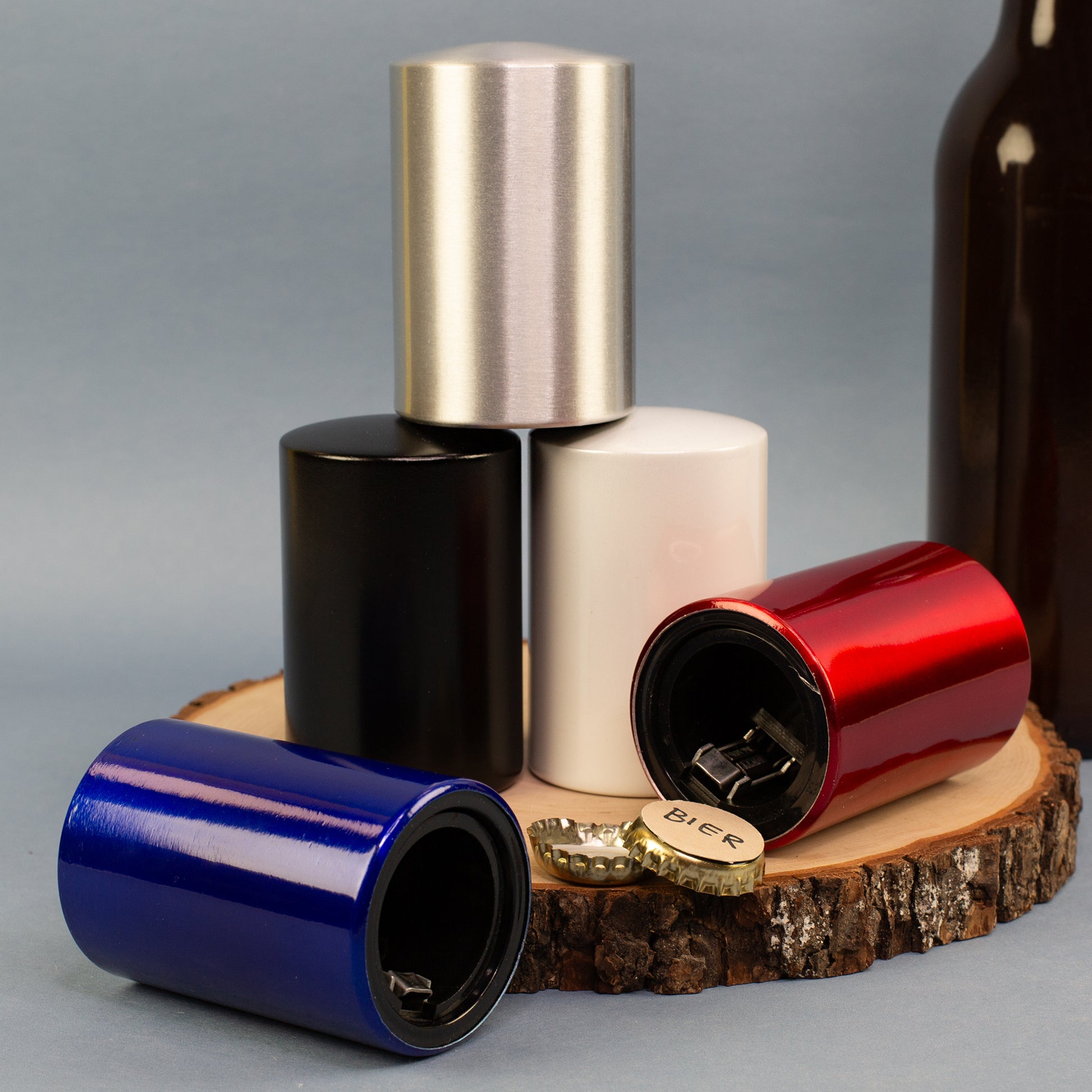 Mehrere Push-Up Flaschenöffner in verschiedenen Farben als Männergeschenk arrangiert