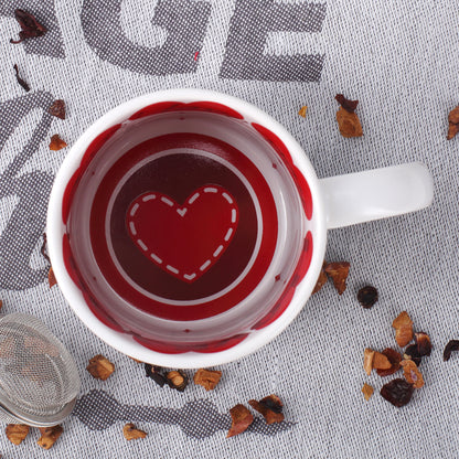 Blick in die Tasse mit rotem Herzdesign und Love-Schriftzügen innen am Tassenrand zum Valentinstag