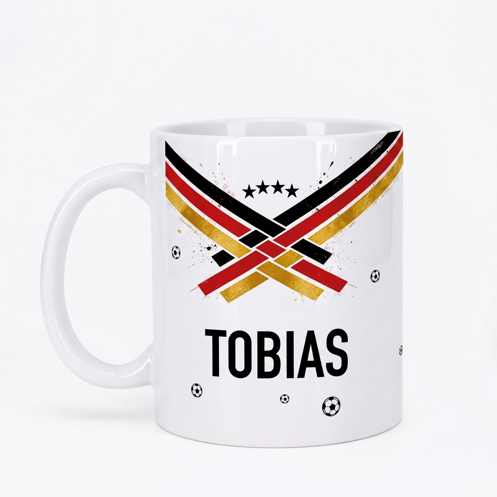 Personalisierte Fußball Tasse mit Name Tobias, schwarz-rot-goldenem Design, Sternen und kleinen Fußbällen auf weißem Hintergrund