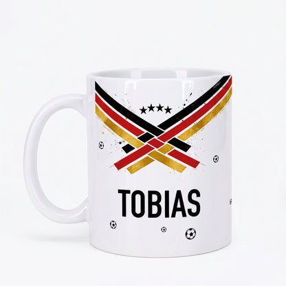 Personalisierte Fußball Tasse mit Name Tobias, schwarz-rot-goldenem Design, Sternen und kleinen Fußbällen auf weißem Hintergrund