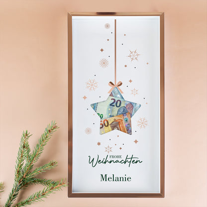 Weihnachtlicher Geldgeschenk Bilderrahmen mit Name Melanie, Stern-Aussparung und sichtbaren Euro-Scheinen vor rosa Hintergrund