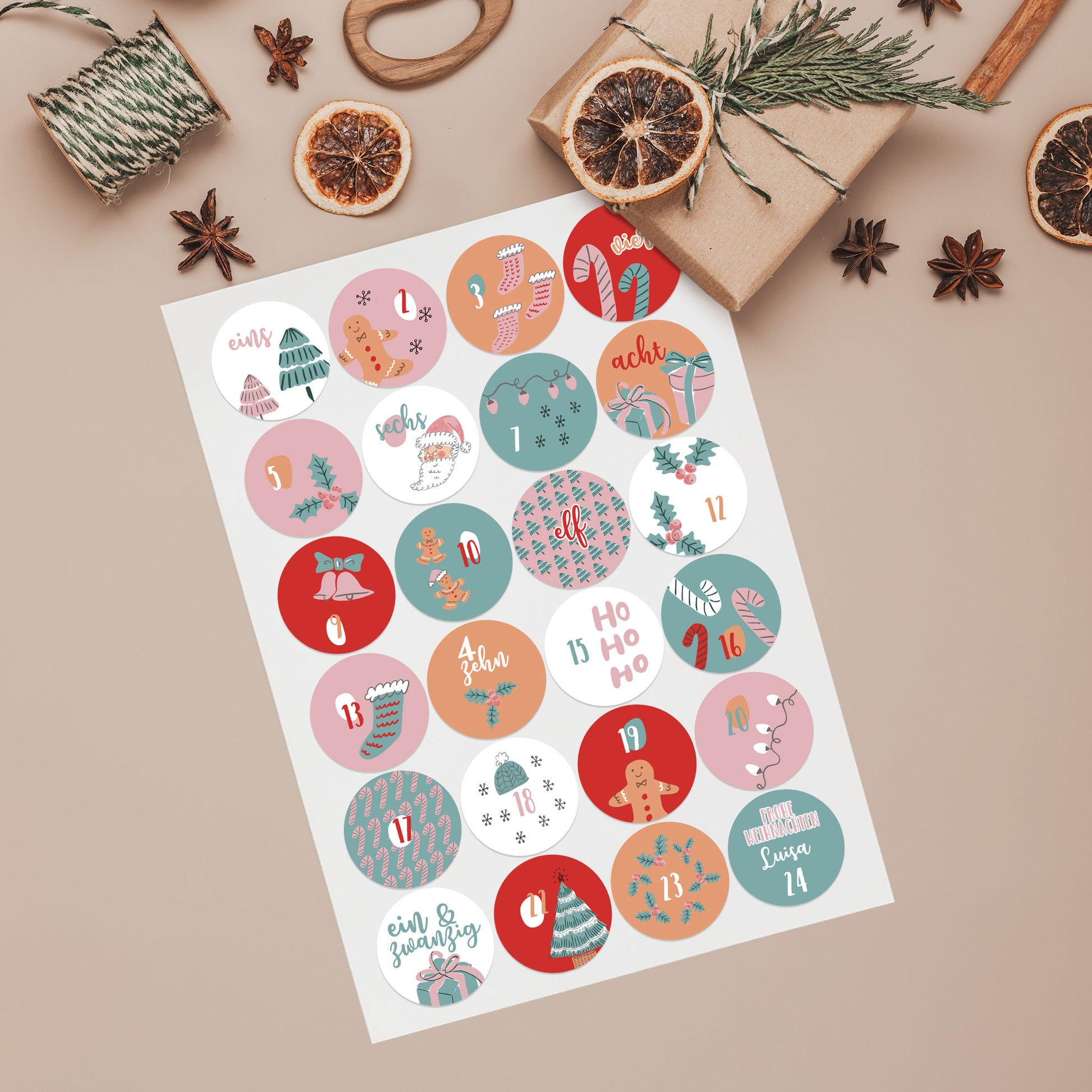 Bogen mit 24 runden Adventskalender-Aufklebern in Rosa & Türkis, nummeriert von 1 bis 24 dekoriert mit kleinen Geschenken und Zubehör