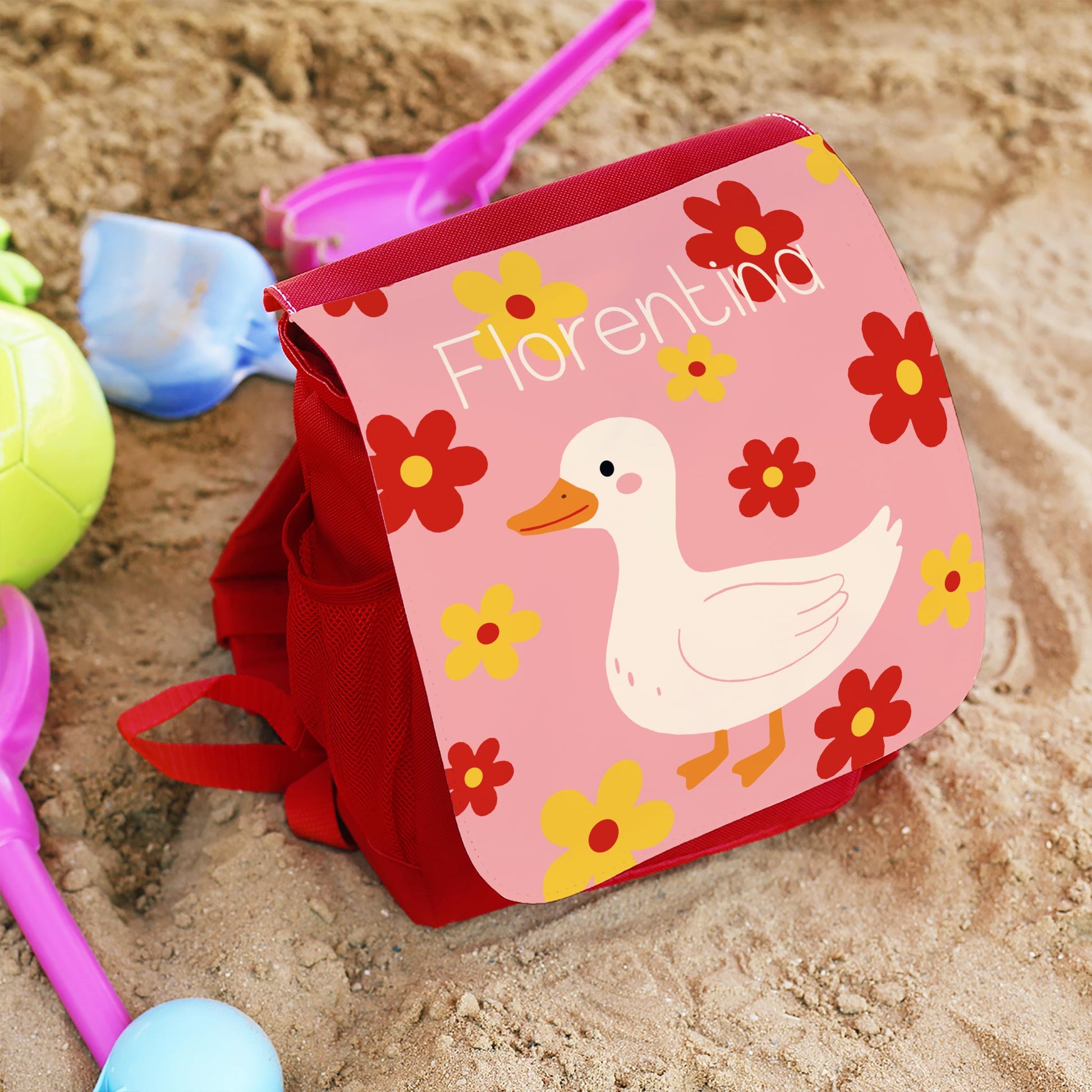 Personalisierter roter Kinderrucksack mit Gans Motiv, Blumen und Name Florentina im Sandkasten