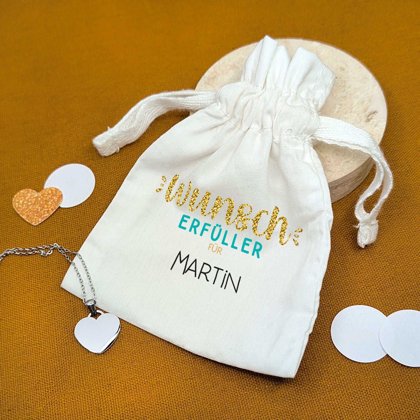 Stoffsäckchen mit Aufdruck Wunscherfüller für Martin, mit Herzanhänger – auf oranger Unterlage
