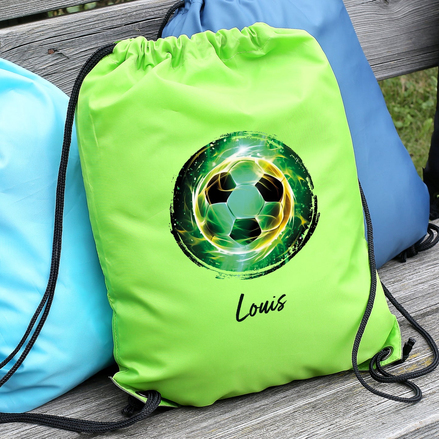 Grüner Sportbeutel mit Fußball-Motiv und Name auf Bank liegend